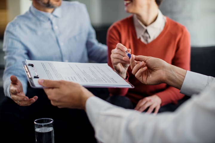 /media/closeup-unrecognizable-couple-signing-contract-with-financial-advisor.jpg